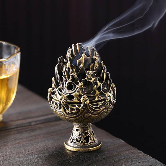 Copper Mountain Incense Burner – Low angle on dark wood with teacup, smoke rising from openwork peaks, tea ceremony decor