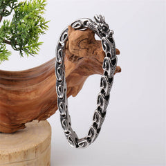 Dragon Titanium Steel Luck Bracelet Bangle - dragon head gripping pearl on wood with greenery, antique silver finish