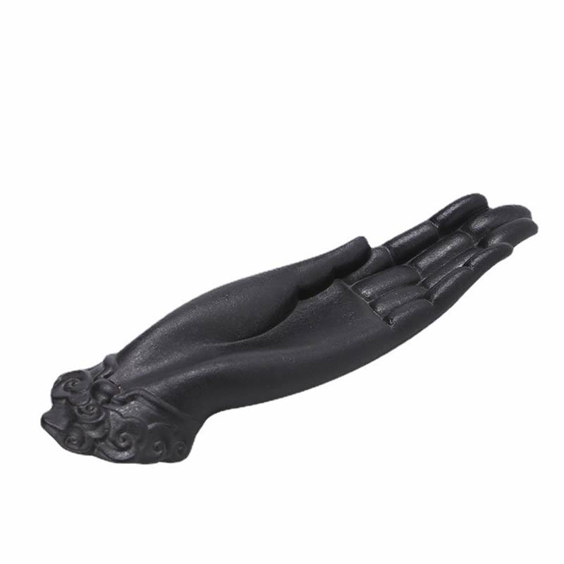 Buddha Hand Incense Burner – matte black ceramic hand sculpture on white, cloud-carved wrist detail, elegant