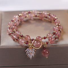 Double-wrap strawberry quartz bracelet with alternating pink beads and burgundy garnet accents gold tone findings leaf crystal spray and teardrop dangle charm