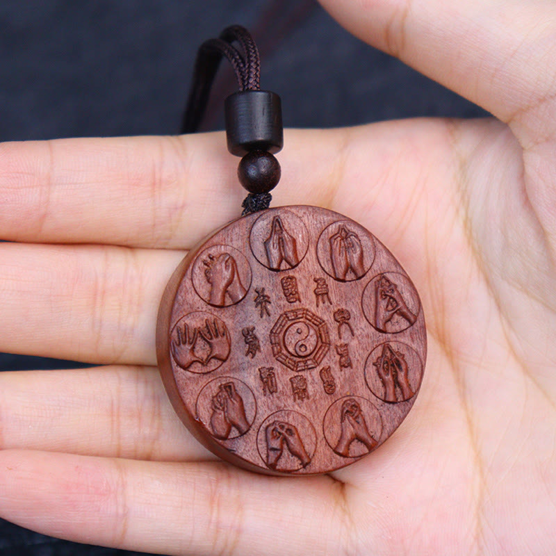 Lightning Struck Jujube Wood Pendant – Hand-held round wooden amulet showing carved mudras and yin-yang bagua design, natural