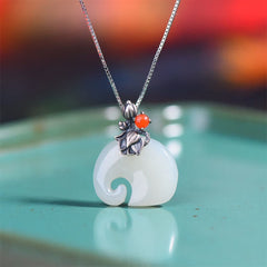 White Jade Elephant Lotus Necklace - White jade pendant with silver lotus flower and carnelian on teal ceramic