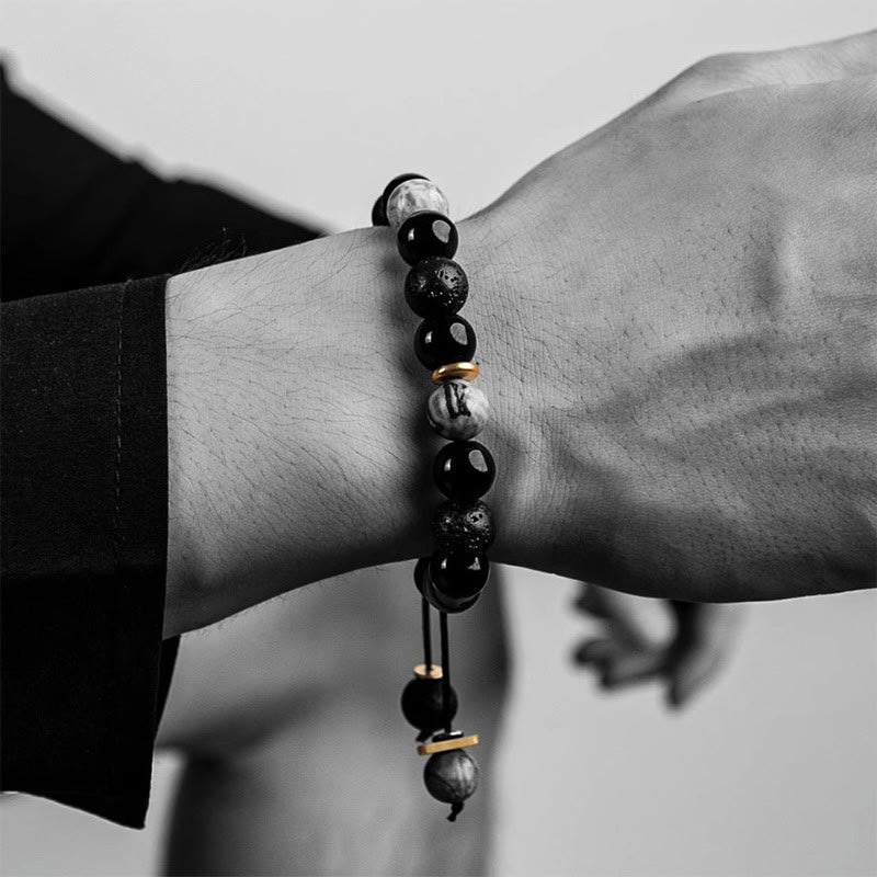 Black Obsidian Lava Rock Bracelet – Wrist shot showing beaded bracelet with gold spacers, adjustable cord