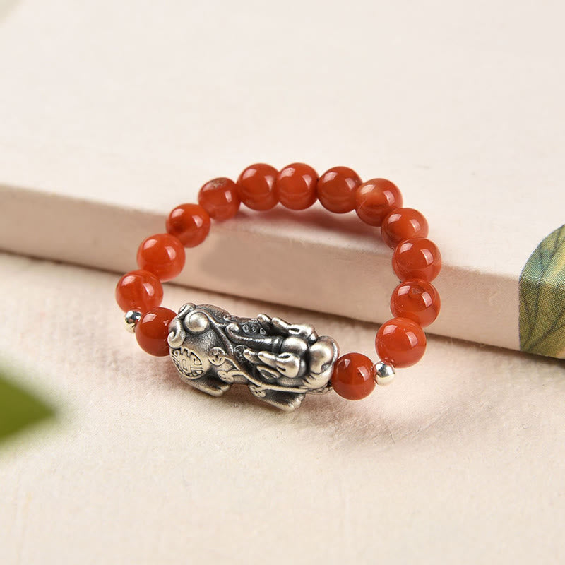 Silver Red Agate PiXiu Ring – Red agate ring with ornate silver PiXiu on soft neutral surface