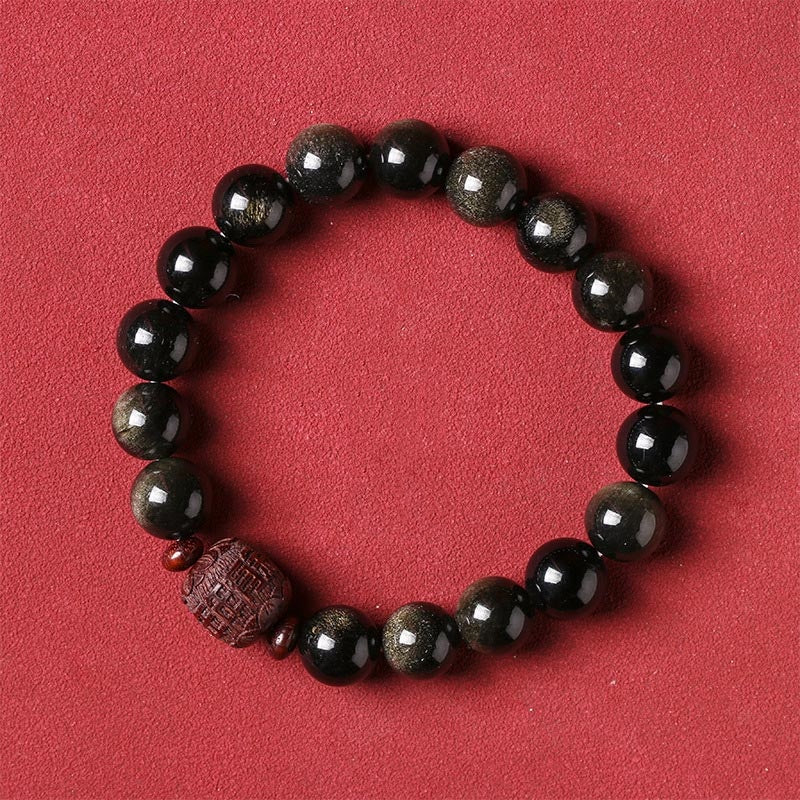 Gold Sheen & Rainbow Obsidian Fu Bracelet – on red background, gold-sheen obsidian bead detail