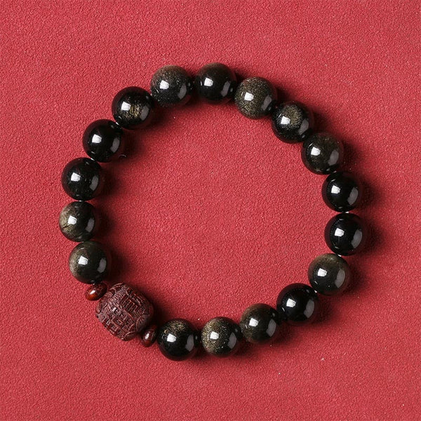Gold Sheen & Rainbow Obsidian Fu Bracelet – on red background, gold-sheen obsidian bead detail