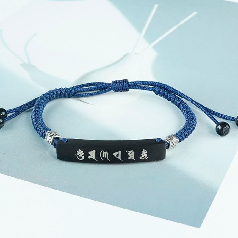 Om Mani Padme Hum Ebony Bracelet – Clean studio shot of blue cord bracelet with silver mantra plaque