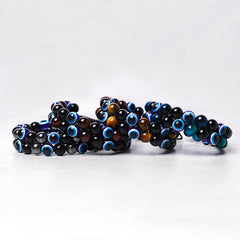 Evil Eye Hematite Tiger Eye Bracelet – five stacked bracelets showing black tiger eye and evil eye bead variations