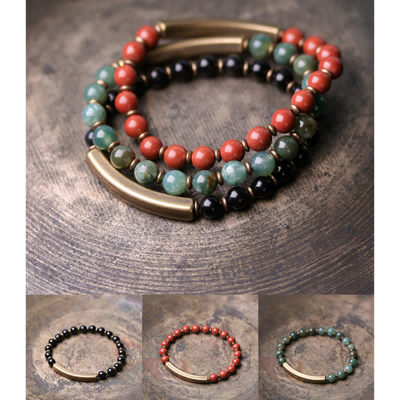 Red jasper moss agate obsidian bracelet set of three on weathered wood, coral-red green and black bead bracelets with matching antique brass bars, couples peace bracelet collection