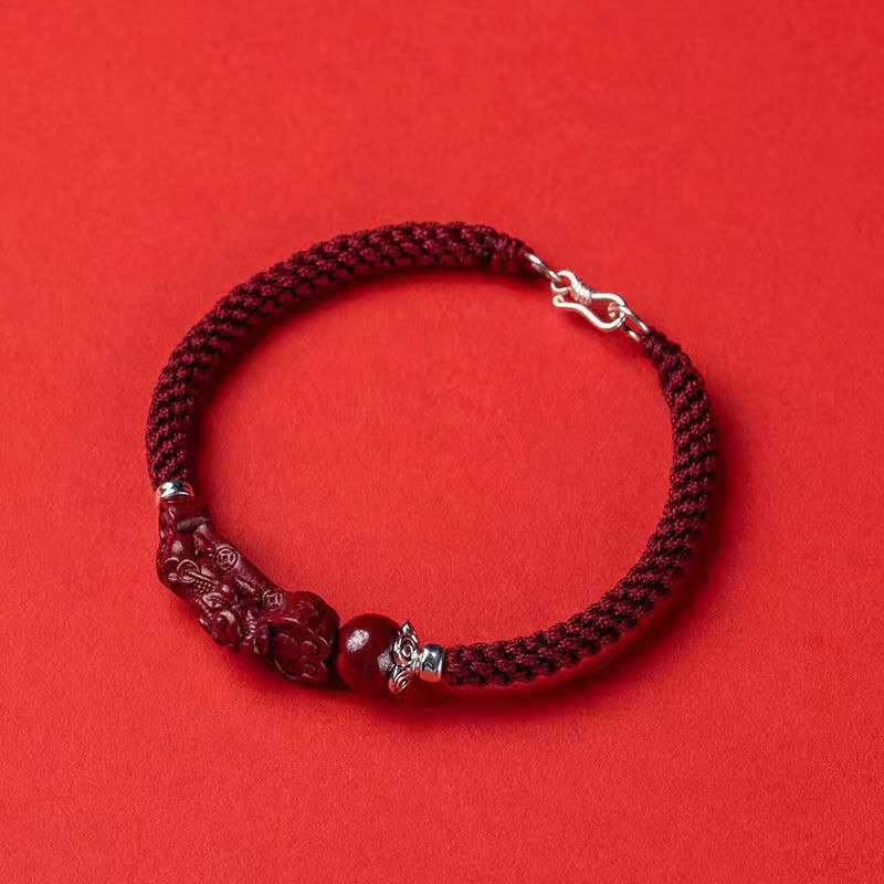 Handcrafted PiXiu Cinnabar Wealth Luck Braided Bracelet – full circle view on bright red background, lucky amulet