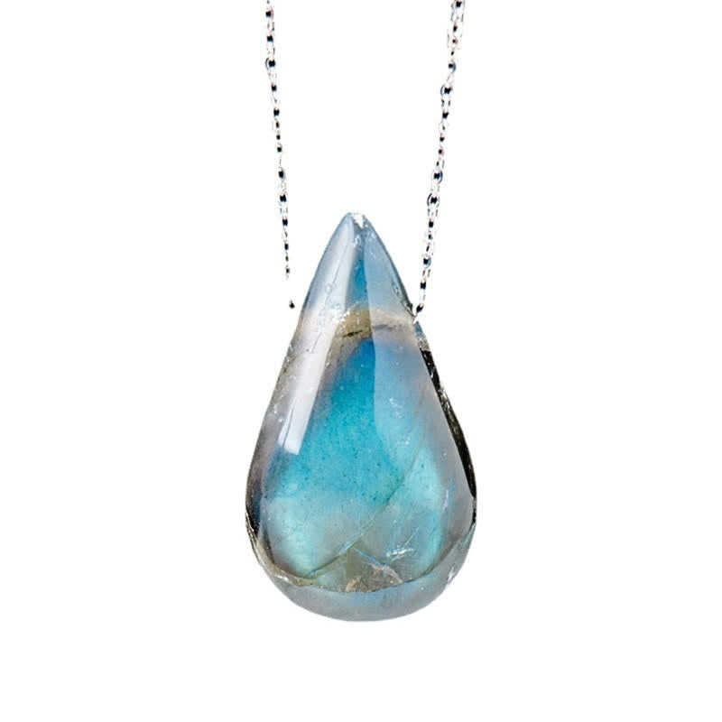 Labradorite water drop pendant close-up showing translucent blue-green iridescent labradorite teardrop cabochon with natural mineral inclusions on silver chain for healing transformation jewelry