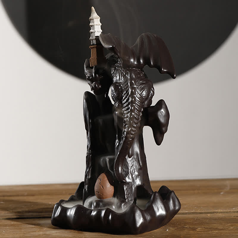 Nordic Dragon Backflow Incense Burner with dragon egg and smoke waterfall, dark ceramic on light wood, backflow incense holder