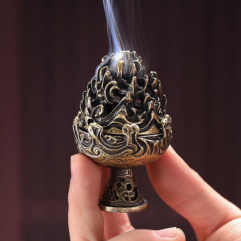 Handheld Bronze Incense Burner – Close-up fingers holding small censer with rising smoke, dark warm background, scale demo