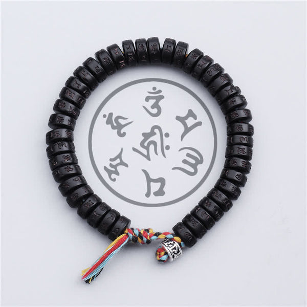 Coconut Shell Mantra Bracelet - Top-down circular view of carved mantra discs, five-color Buddhist tassel