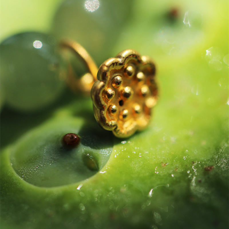Jade Lotus Abundance Bracelet – Macro of gold lotus pod charm on jade bead strand, lotus charm detail