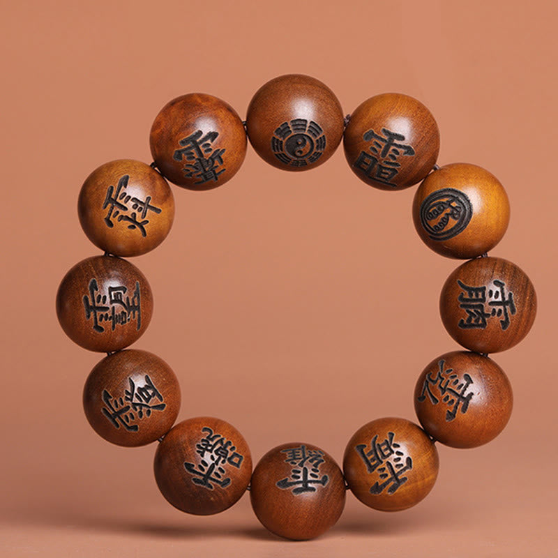 Lightning Struck Jujube Wood Taoist Bracelet - Round wooden bracelet with Taoist symbols on terracotta backdrop, engraved bead bracelet