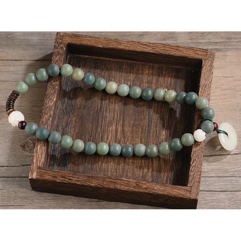 Cyan Bodhi Seed Jade Peace Buckle Bracelet - double-wrap green bead bracelet in wooden tray, artisan craft