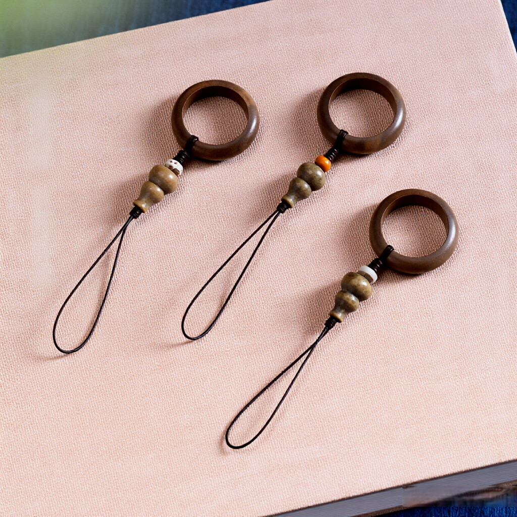 Sandalwood Phone Grip – Three assorted sandalwood ring lanyards flat lay on textured fabric, multi-style phone grip set