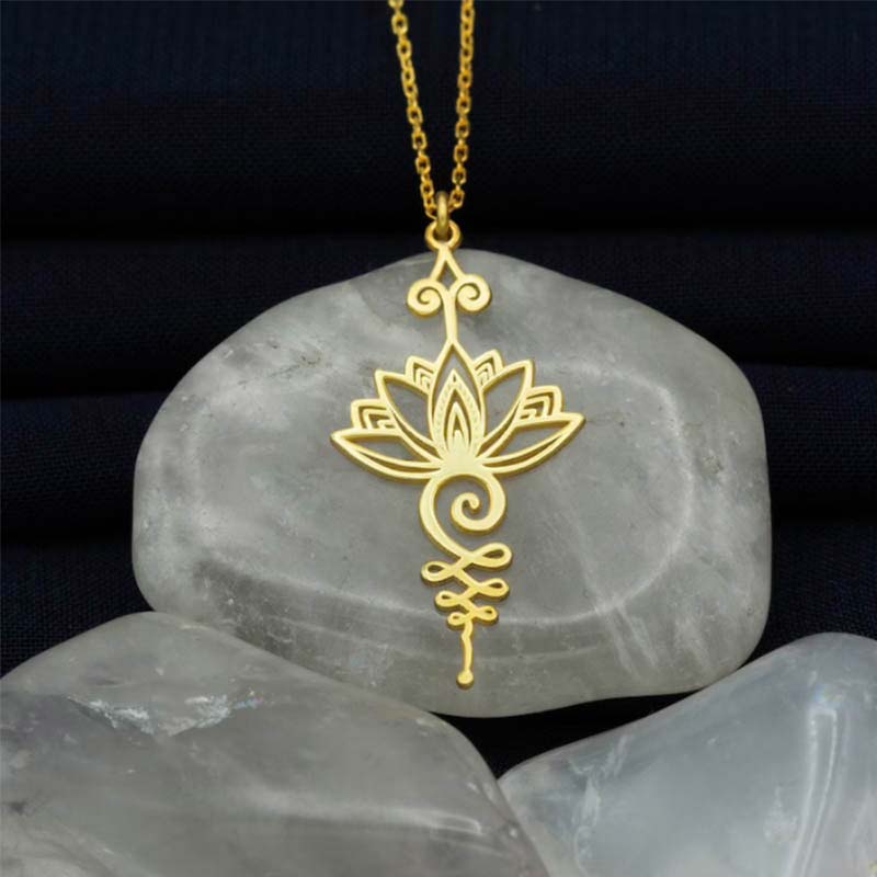 Lotus Luck Wealth Titanium Necklace – gold lotus unalome pendant on chain over pale stones, wealth