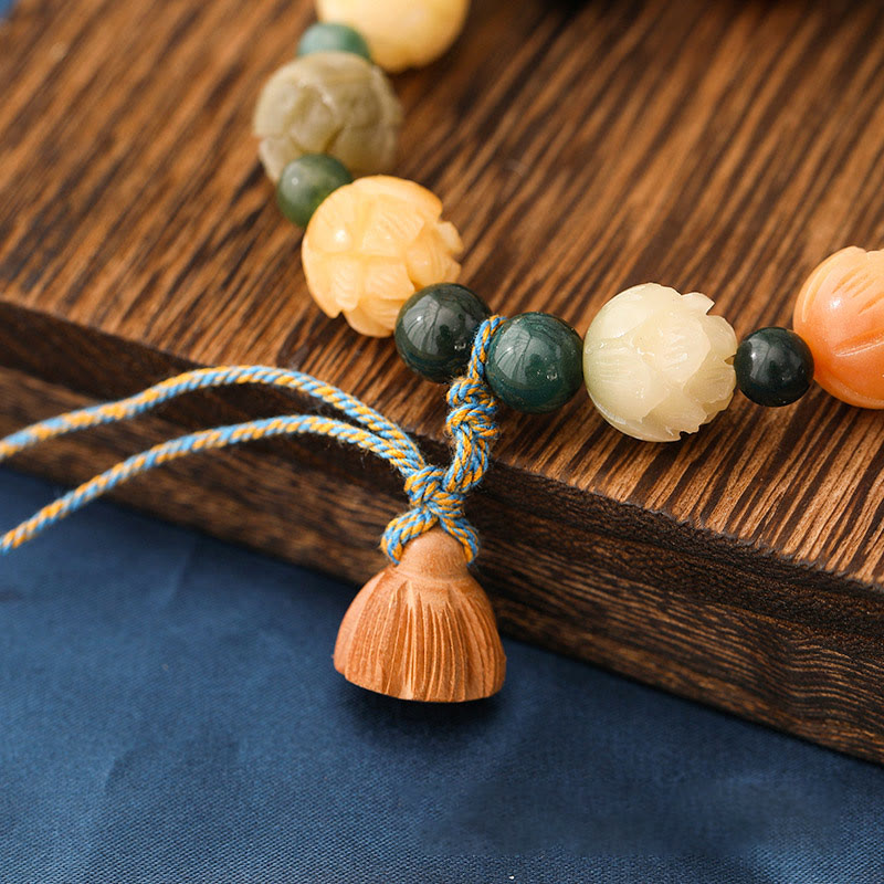 Bodhi Seed Moss Agate Lotus Peace Bracelet - wood grain backdrop, bead texture, grounded