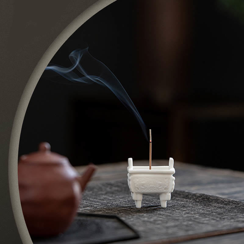 Dragon Ceramic Incense Burner – ding vessel with tea set on gray mat, relief carvings, cultural