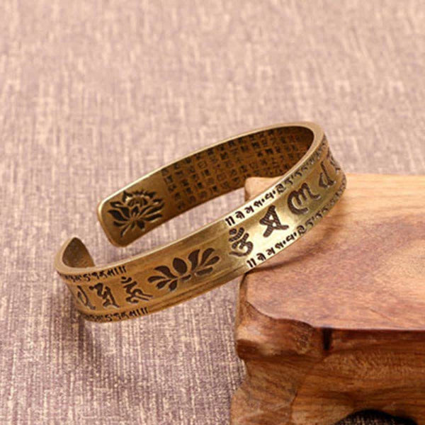 Om Mani Padme Hum Dragon Phoenix Bracelet - Brass cuff with lotus and mantra engravings on wooden stand, Sacred