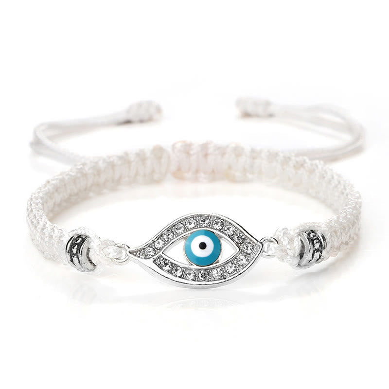 White cord evil eye bracelet with silver turquoise evil eye crystal charm on white bg