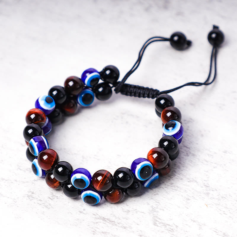 Evil Eye Tiger Eye Bracelet – alternating black amber and cobalt evil eye beads on marble background