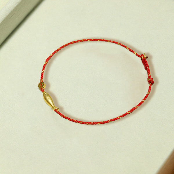 14K Gold Plated Koi Braided Bracelet – worn on wrist showing gold koi pendant on red braided string, luck jewelry