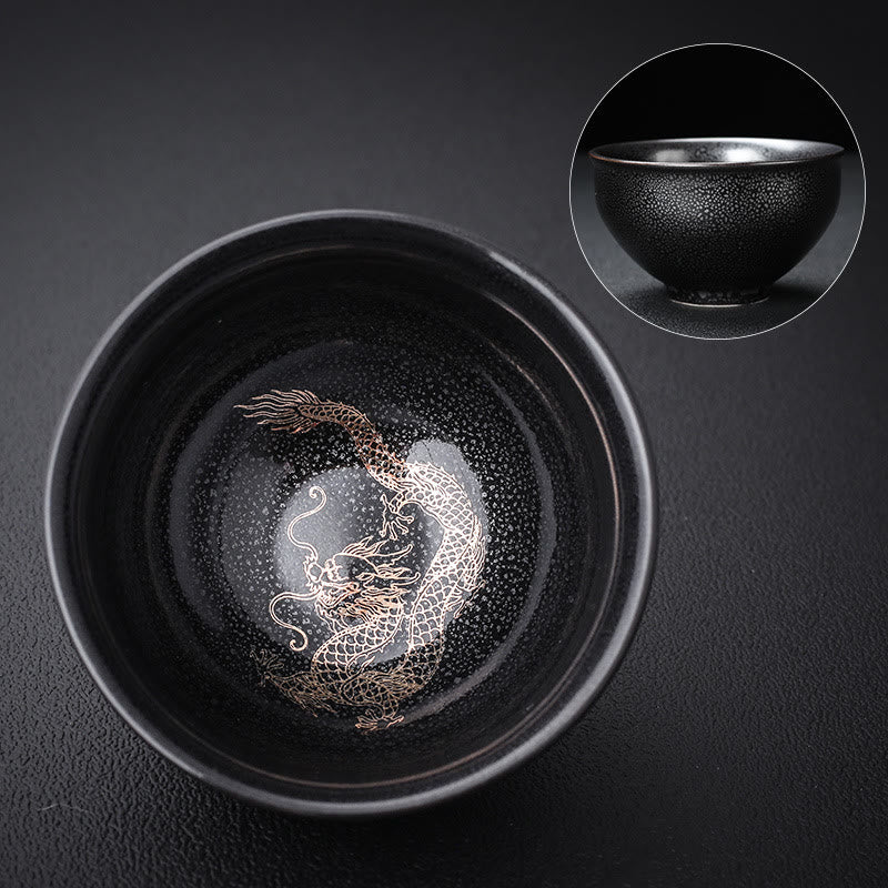 Gold Leaf Jianzhan Teacup – Side angle showing gold dragon phoenix on dark tenmoku glaze, tea ceremony