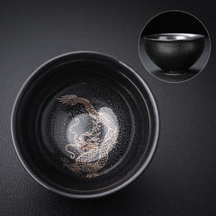 Gold Leaf Jianzhan Teacup – Side angle showing gold dragon phoenix on dark tenmoku glaze, tea ceremony