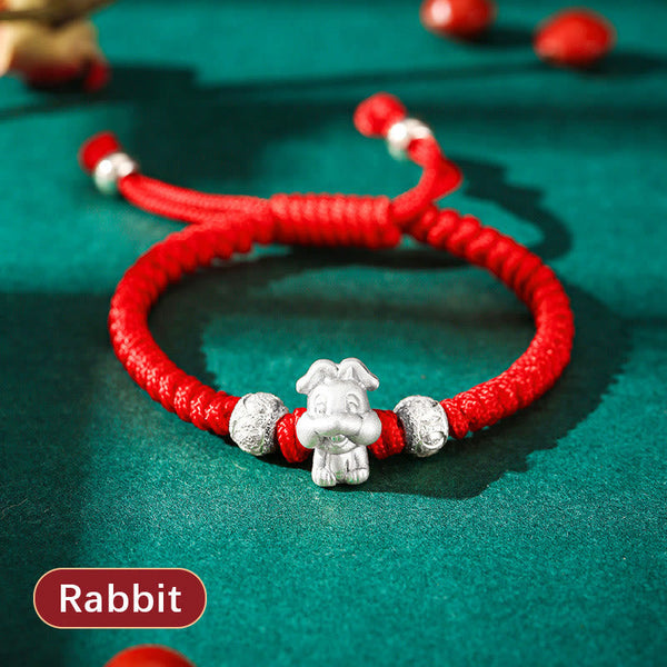 999 Sterling Silver Zodiac Red Rope Kids Bracelet - Silver charm on red cord, adult and child hands, heritage gift