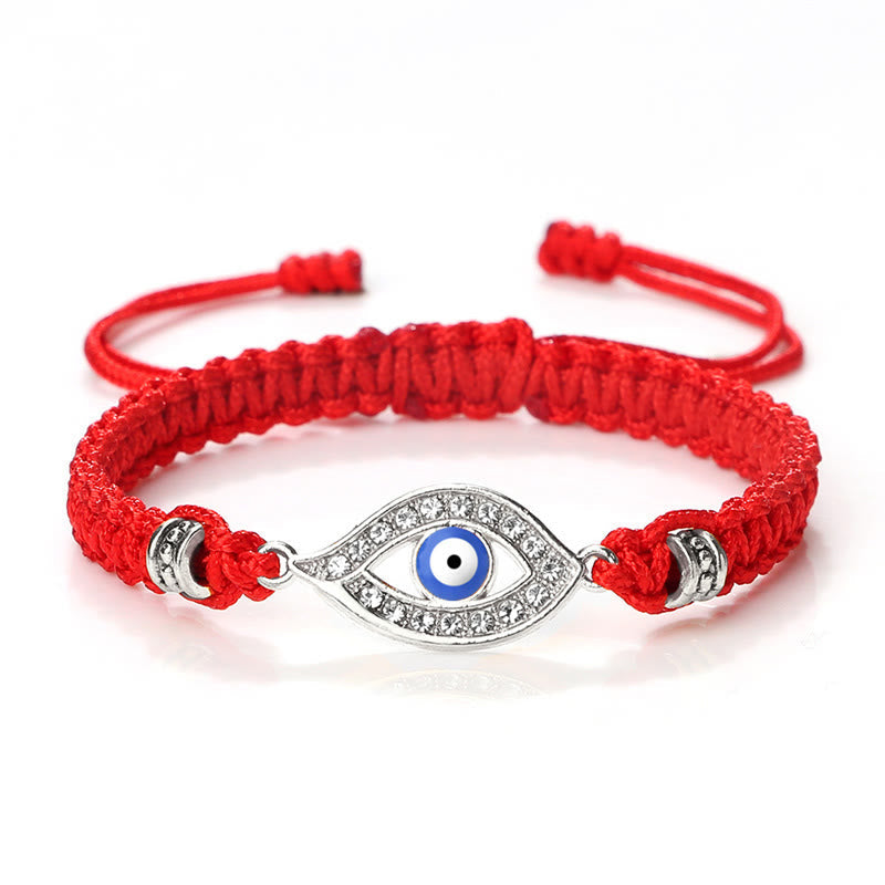 Red cord evil eye bracelet with silver blue evil eye crystal charm on white background