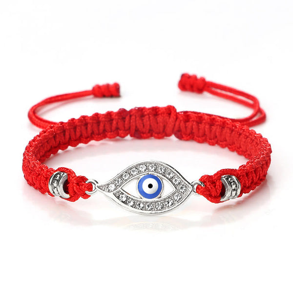 Red cord evil eye bracelet with silver blue evil eye crystal charm on white background