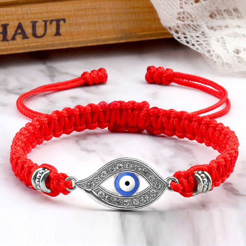Red cord evil eye bracelet with silver blue evil eye pave charm, marble lifestyle