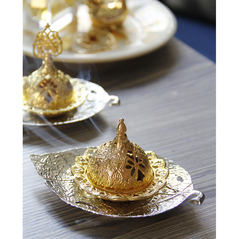 Tibetan Gold Leaf Coaster Incense Burner – Gold burners with smoke on silver leaf trays in bokeh, brass meditation set