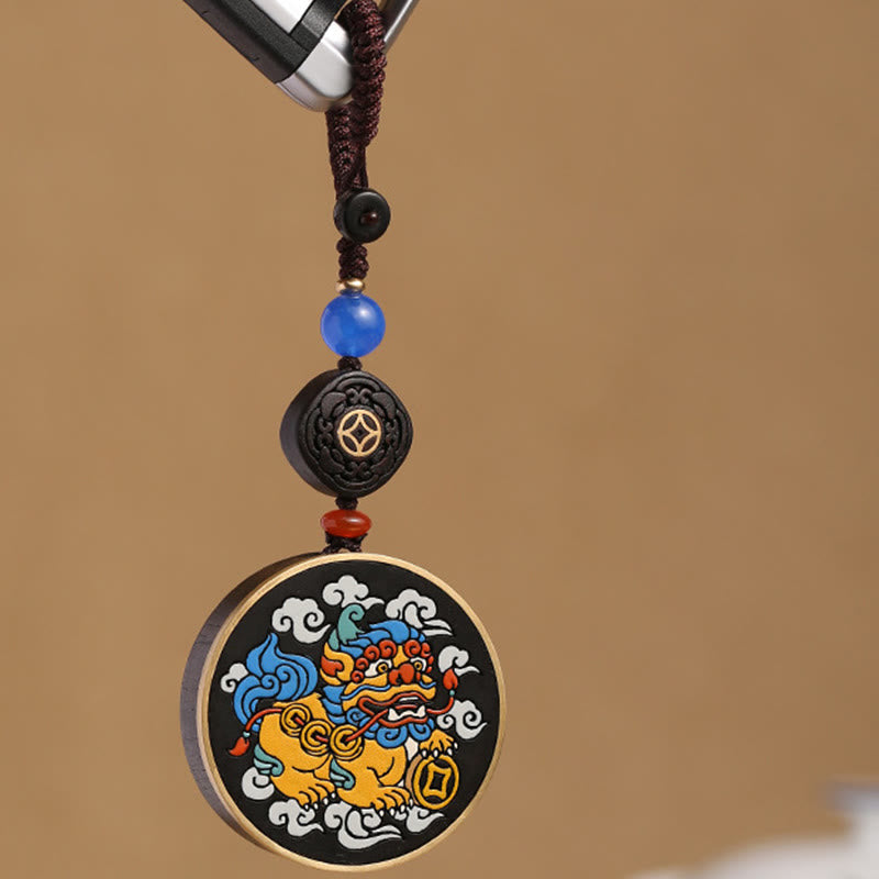 PiXiu Coin Keychain – Dangling from car key against tan background, amulet keychain