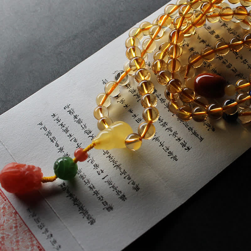 Citrine Mala Bracelet – Woman wearing citrine mala bracelet, coral PiXiu pendant on wrist