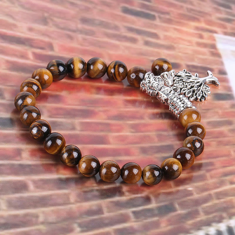 Tree of Life tiger eye bracelet with golden-brown chatoyant beads, ornate silver clasp with decorative filigree detailing.