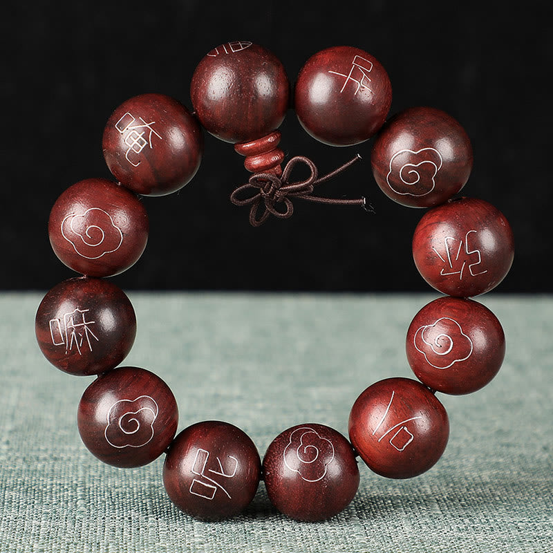 Sterling Silver Sandalwood Mantra Bracelet – on dark sage fabric showing polished wood grain, men’s bead bracelet