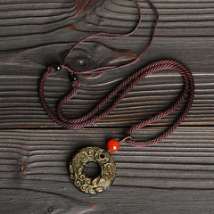 Peace Buckle PiXiu Necklace – Full necklace with purple rope and gold sheen obsidian disc on dark wood, fortune accessory