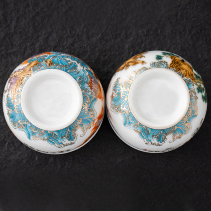 Golden Eagle Dragon Gilt Ceramic Teacup – upside-down base view of paired cups with turquoise wave and gold mountain designs, craft