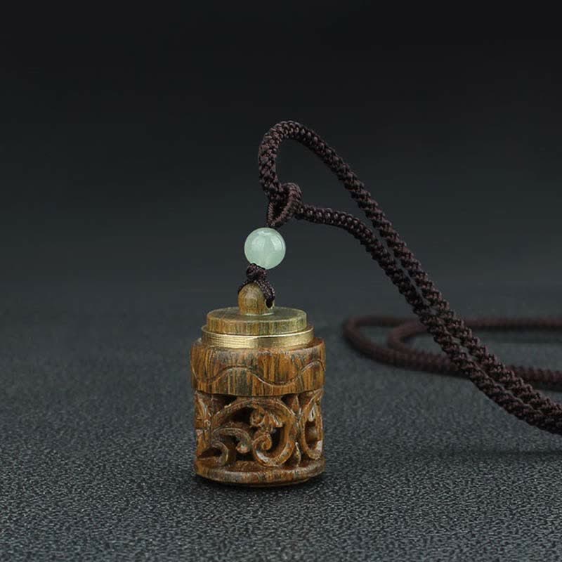 Om Mani Padme Hum Necklace – Cylindrical carved wood pendant with scroll openwork, brass rim accents, jade bead