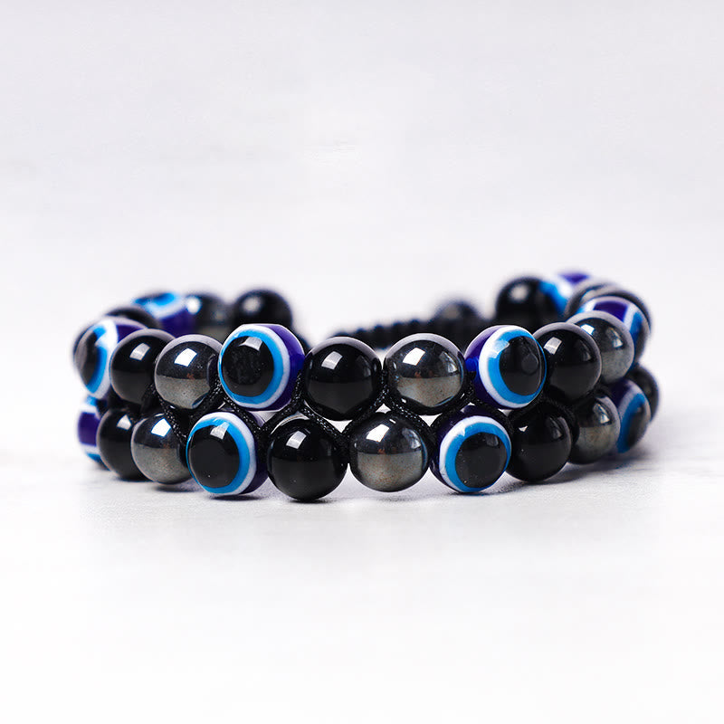 Evil Eye Tiger Eye Bracelet – double-strand black hematite and blue evil eye beads on white background