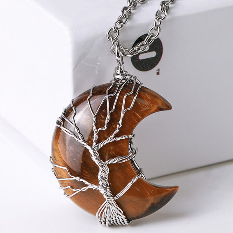 Quartz Crystal Moon Tree of Life Pendant – tiger eye moon pendant on white display stand, three-quarter, crystal jewelry