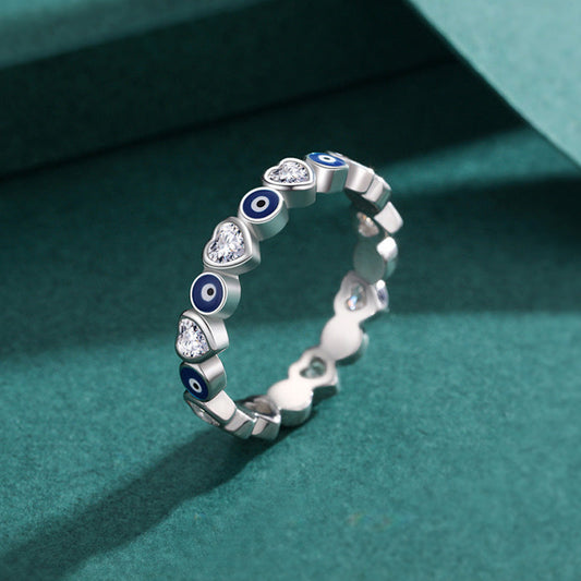 925 Sterling Silver Evil Eye Heart Ring – heart and evil eye pattern on teal velvet jewelry display