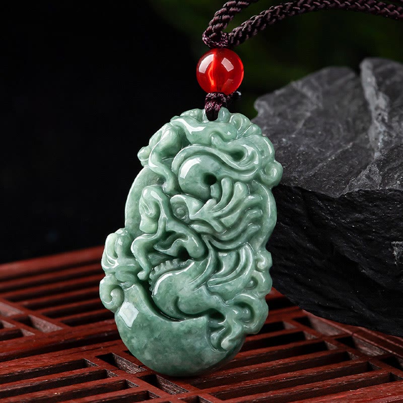 Jade Zodiac Prosperity Necklace – Carved dragon pendant on dark wood lattice with stone prop, auspicious