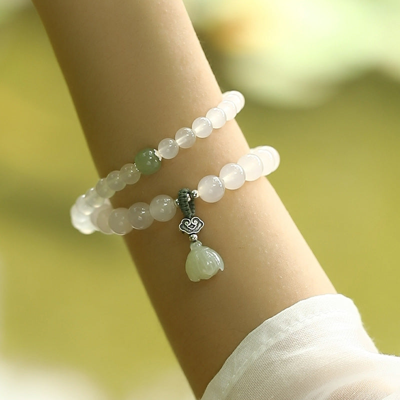White Agate Jade Lotus Bracelet - Double-strand on wrist with green accent bead and silver ruyi charm, gemstone bracelet