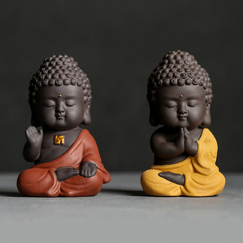Small Buddha Purple Clay Decoration – orange and yellow robe pair, studio front view, prayer and blessing gestures, mindful d