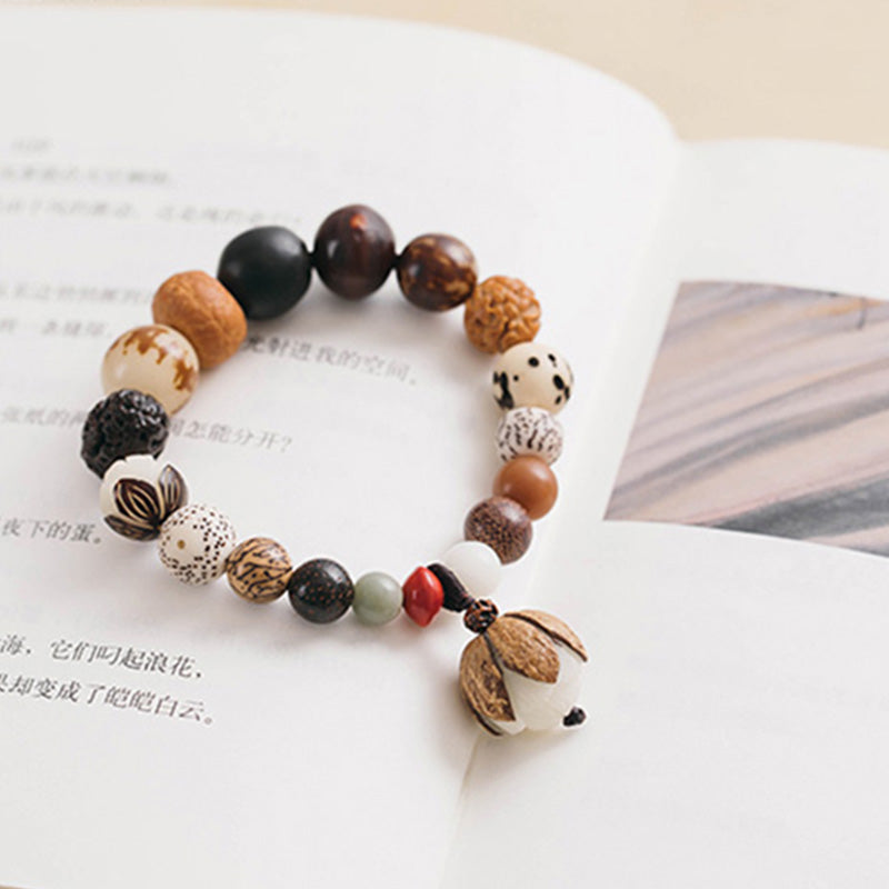 Bodhi Seed Lotus Bracelet – On open book with split pod charm and tassel, natural seed bracelet